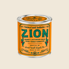 Zion candle in a tin with an orange label on a white background