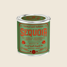 Green and red candle can labeled 'Sequoia' 